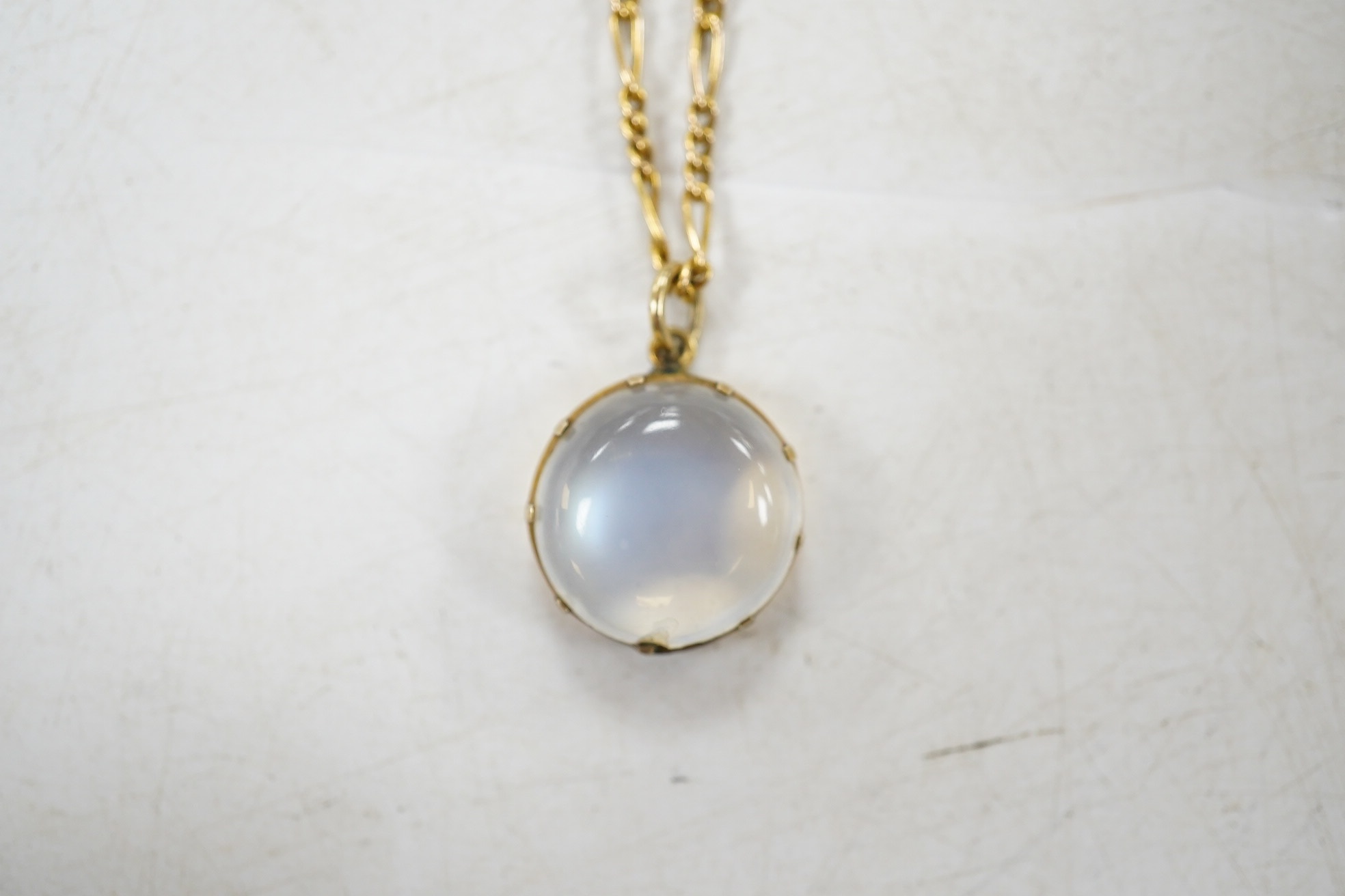 A yellow metal and single stone cabochon moonstone set pendant necklace, overall 42cm, gross weight 5.1 grams. Condition - fair